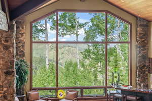 Unfurnished sunroom featuring wooden ceiling and lofted ceiling