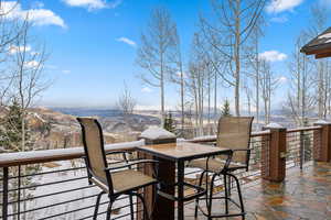 Snow covered deck with a mountain view