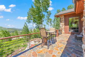 View of patio / terrace with a mountain view and a balcony