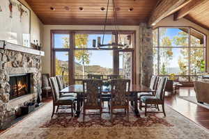 Dining space featuring a mountain view, hardwood / wood-style flooring, an inviting chandelier, and a wealth of natural light