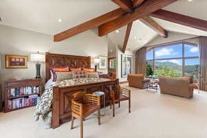 Carpeted bedroom featuring a mountain view, high vaulted ceiling, and beamed ceiling