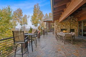 View of patio featuring an outdoor stone fireplace