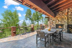 View of patio / terrace featuring an outdoor stone fireplace