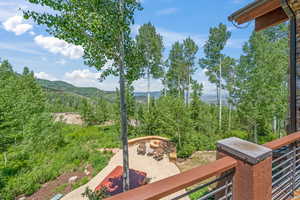 Exterior space with a mountain view, a balcony, and an outdoor fire pit