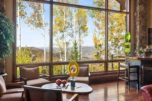 Sunroom / solarium featuring a mountain view and plenty of natural light