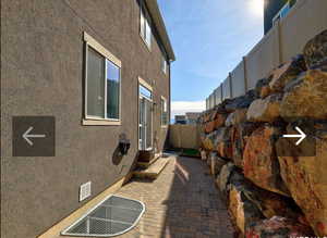 View of side of home featuring a patio area
