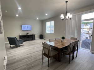 Dining room featuring a notable chandelier and light hardwood / wood-style flooring