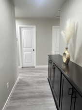 Hall featuring light wood-type flooring