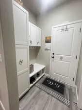 Mudroom with light hardwood / wood-style floors