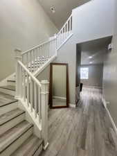 Stairway featuring wood-type flooring