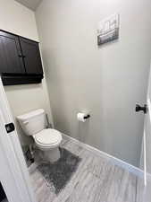 Bathroom with wood-type flooring and toilet