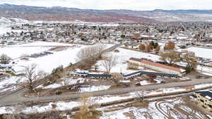 Snowy aerial view featuring a mountain view