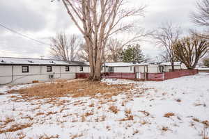 View of yard covered in snow