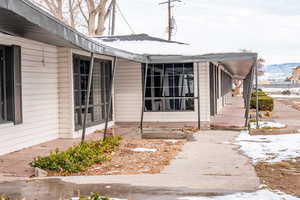 View of snow covered property entrance