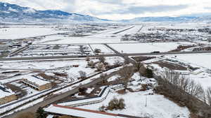 Snowy aerial view featuring a mountain view