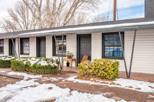 View of snow covered property entrance