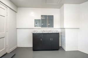 Interior space featuring concrete flooring and electric panel