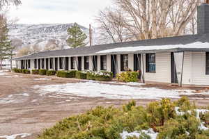 Snow covered building featuring a mountain view