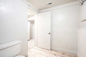 Bathroom with wood-type flooring and toilet