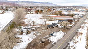 Snowy aerial view featuring a mountain view