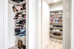 Spacious closet featuring light hardwood / wood-style flooring