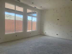 Spare room featuring unfinished concrete flooring
