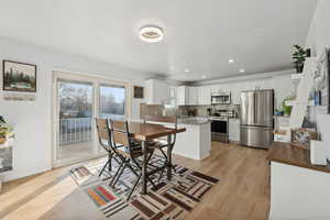 Dining room with light wood-type flooring and sink