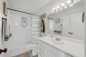 Full bathroom featuring tile patterned floors, vanity, shower / tub combo, and toilet