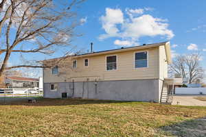 Back of house featuring a yard