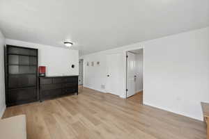 Unfurnished bedroom featuring light wood-type flooring