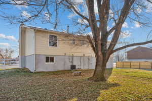 View of property exterior with central AC unit and a lawn