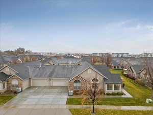 Single story home featuring a front yard, a garage, and central air condition unit