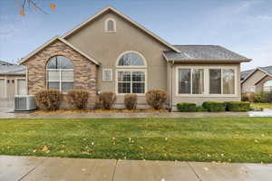 Single story home featuring a front lawn and cooling unit