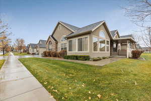 View of property exterior featuring a lawn