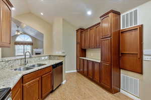 Kitchen featuring lofted ceiling, sink, ceiling fan, appliances with stainless steel finishes, and light hardwood / wood-style floors