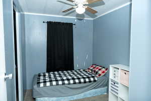 Bedroom with carpet flooring, ceiling fan, and a textured ceiling