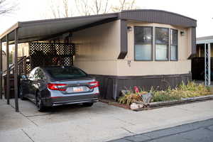 View of property exterior featuring a carport