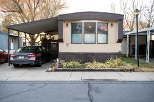 View of front facade with a carport