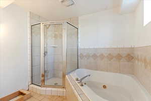 Bathroom with tile patterned floors and separate shower and tub