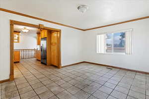 Tiled empty room with crown molding