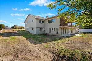 Back of house with a balcony