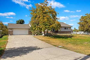 View of front facade with a front lawn and a garage