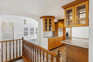 Kitchen with light tile patterned flooring, a textured ceiling, and ornamental molding