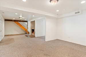 Basement featuring carpet and a fireplace