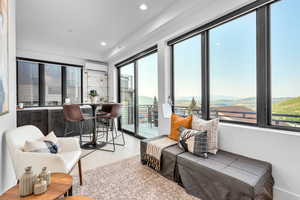 Sunroom featuring a wall mounted air conditioner and a mountain view