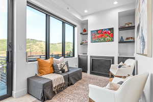 Living area with built in shelves and light colored carpet