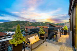 Balcony at dusk with a mountain view