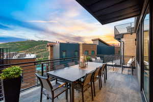 Balcony at dusk featuring central AC