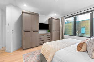 Bedroom with light wood-type flooring and a closet