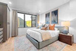 Bedroom with light hardwood / wood-style flooring